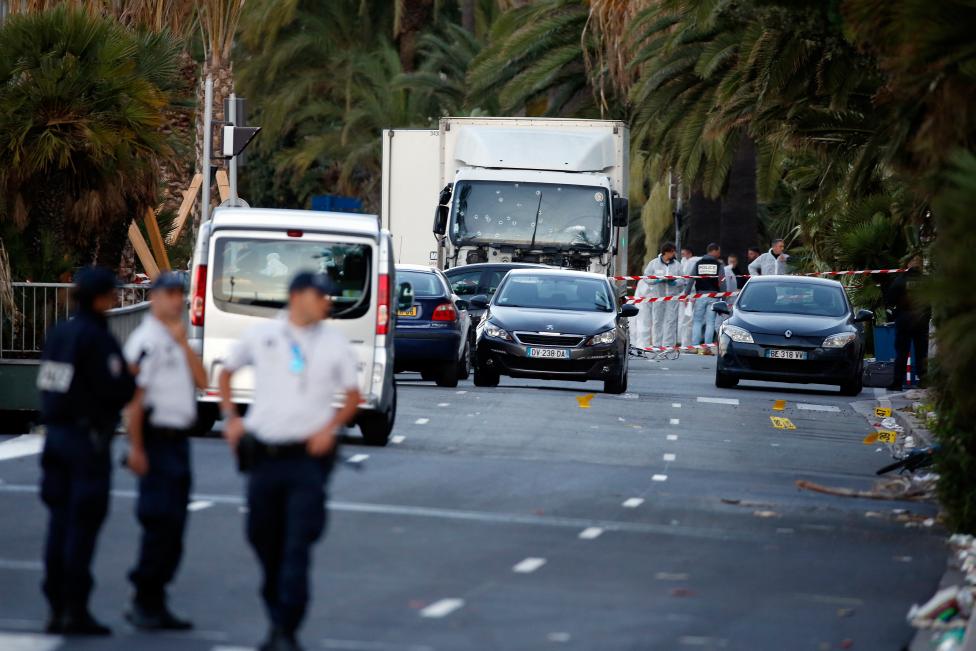 French police continue their investigation as they work near the heavy truck that ran into a crowd at high speed celebrating the Bastille Day July 14 national holiday on the Promenade des Anglais killing 80 people in Nice, France, July 15, 2016. REUTERS/Eric Gaillard
